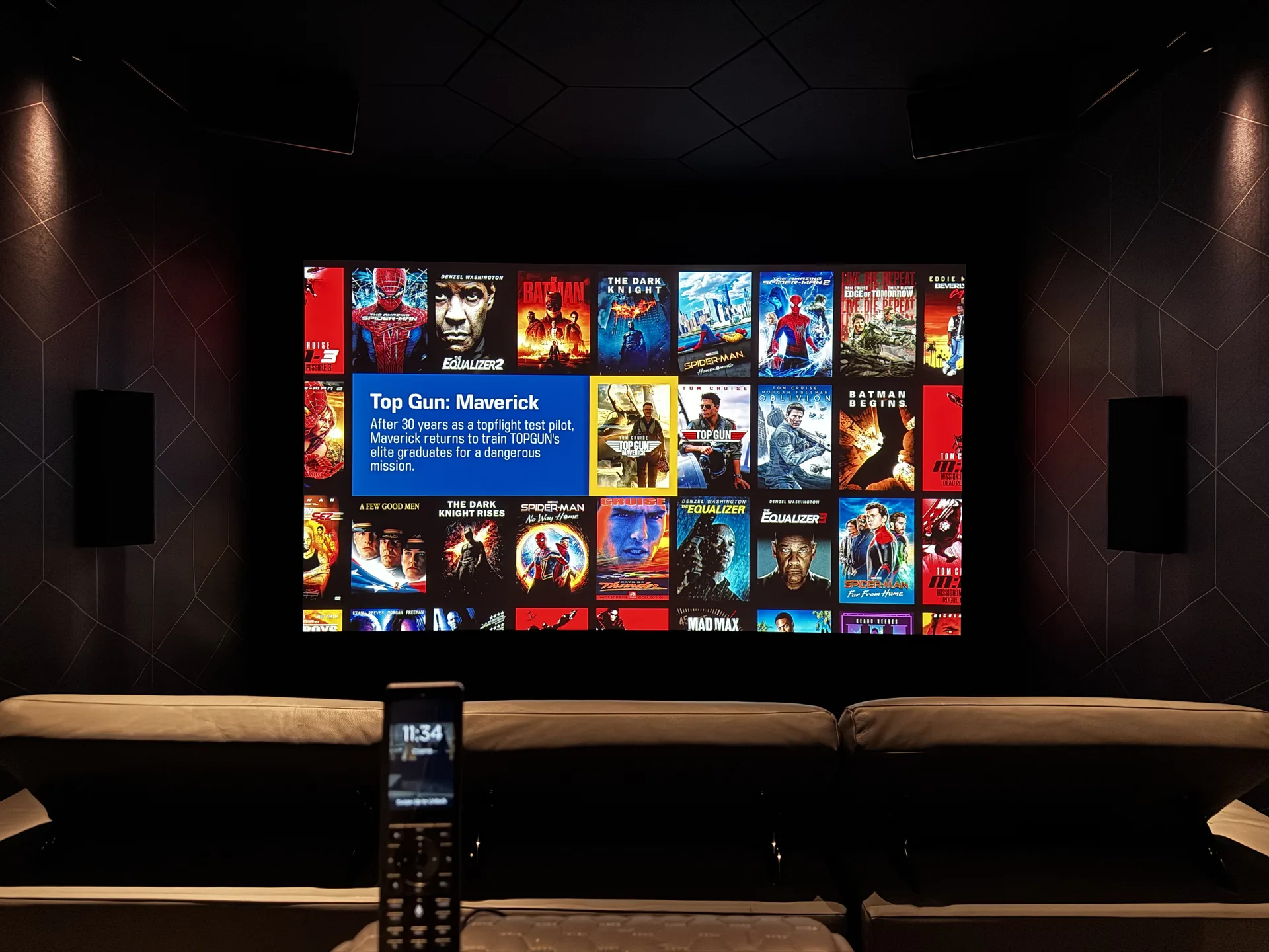 Dedicated home cinema with fabric-wrapped acoustic wall and ceiling panels, a large projection screen and reclining seating