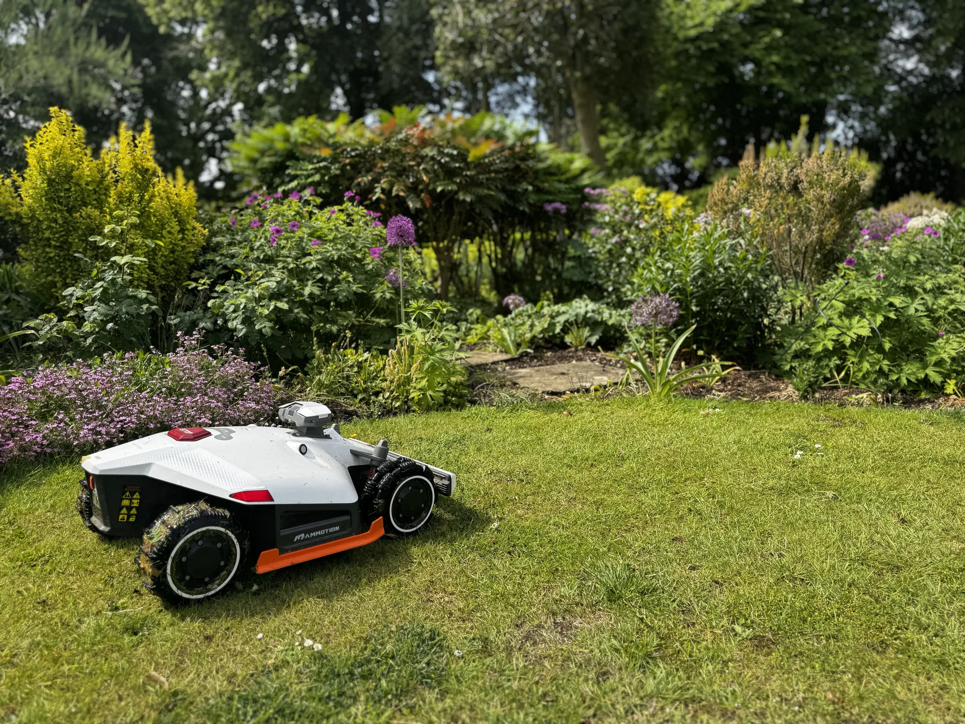 Mammotion Luba 3 robotic lawn mower navigating a well-kept garden without boundary wire